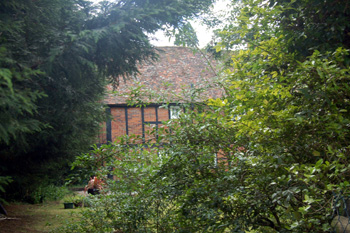 What can be glimpsed of 20-22 Leighton Road June 2008